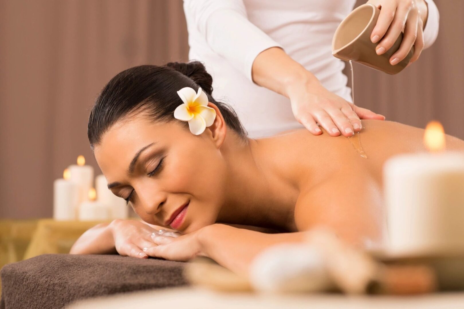 A woman getting a massage from a masseuse.