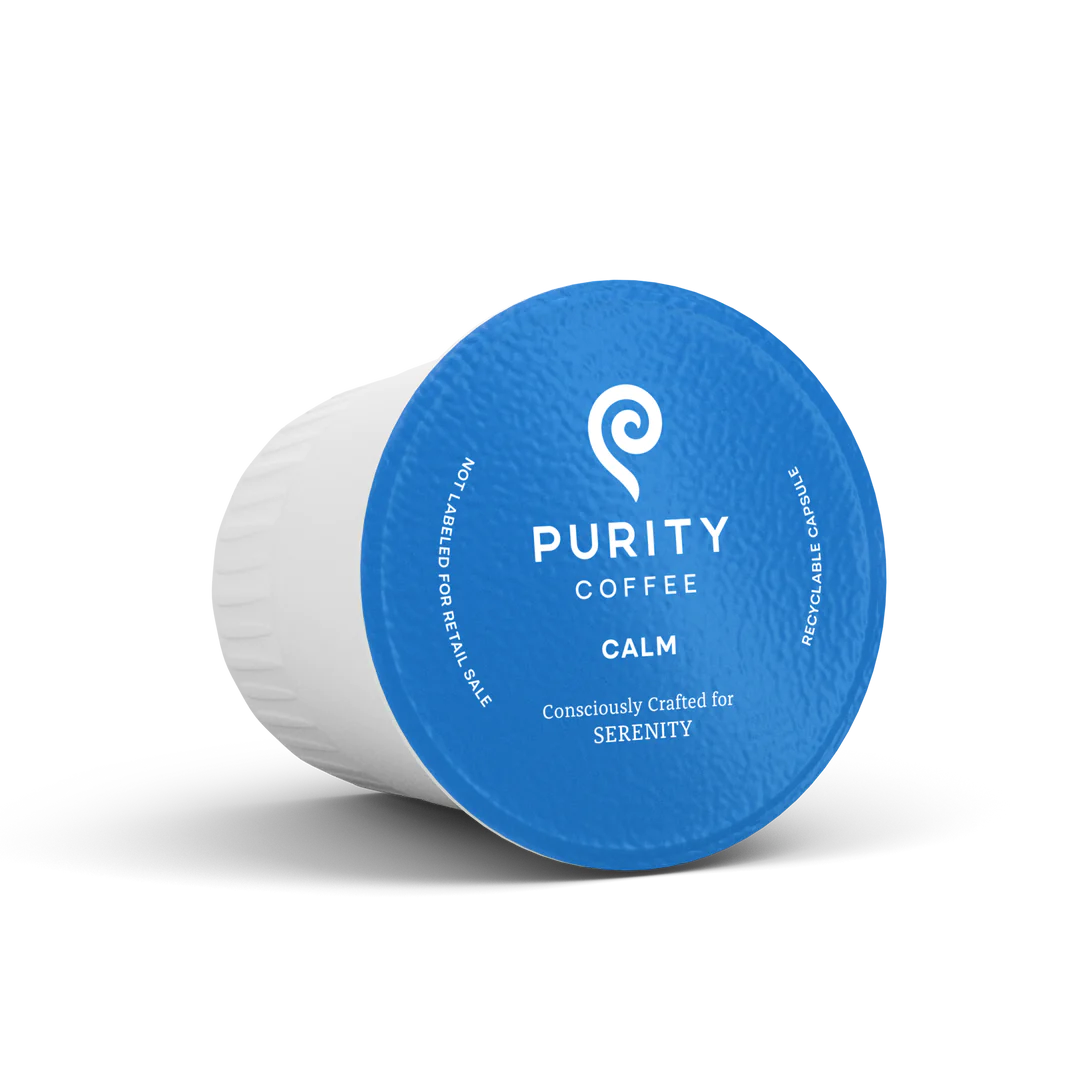 A blue cup of coffee with the word purity on it.