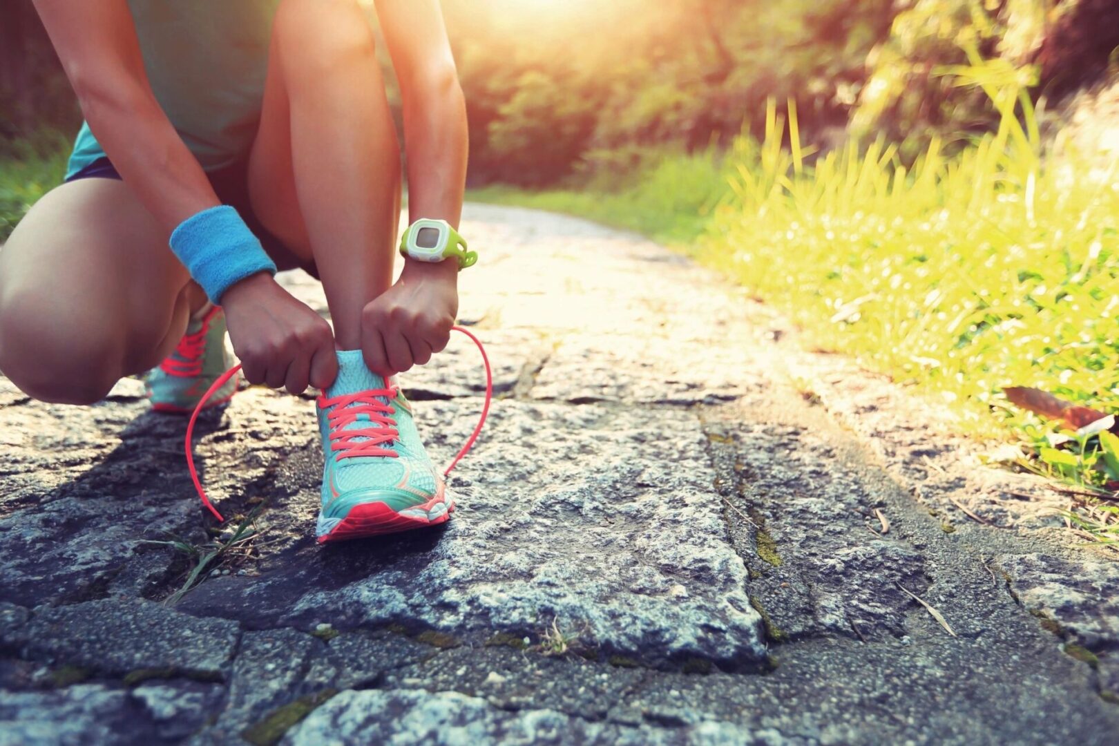 Woman ties her shoe before running.